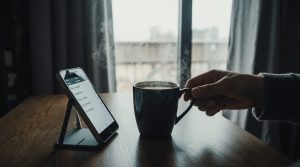 Morning coffee next to a phone displaying Todoist habit reminders.